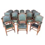 A set of eighteen Arts and Crafts oak library chairs, made by Chamberlain, King & Jones Ltd.