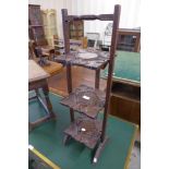 An eastern carved softwood and brass inlaid folding cakestand