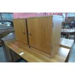 A pair of Austin Suite teak bedside cabinets