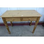 A pine two drawer kitchen table