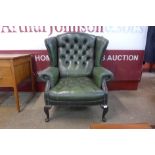 A green leather Chesterfield wingback armchair