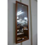 A rectangular teak framed mirror