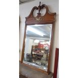 A French Empire style walnut and parcel gilt framed mirror