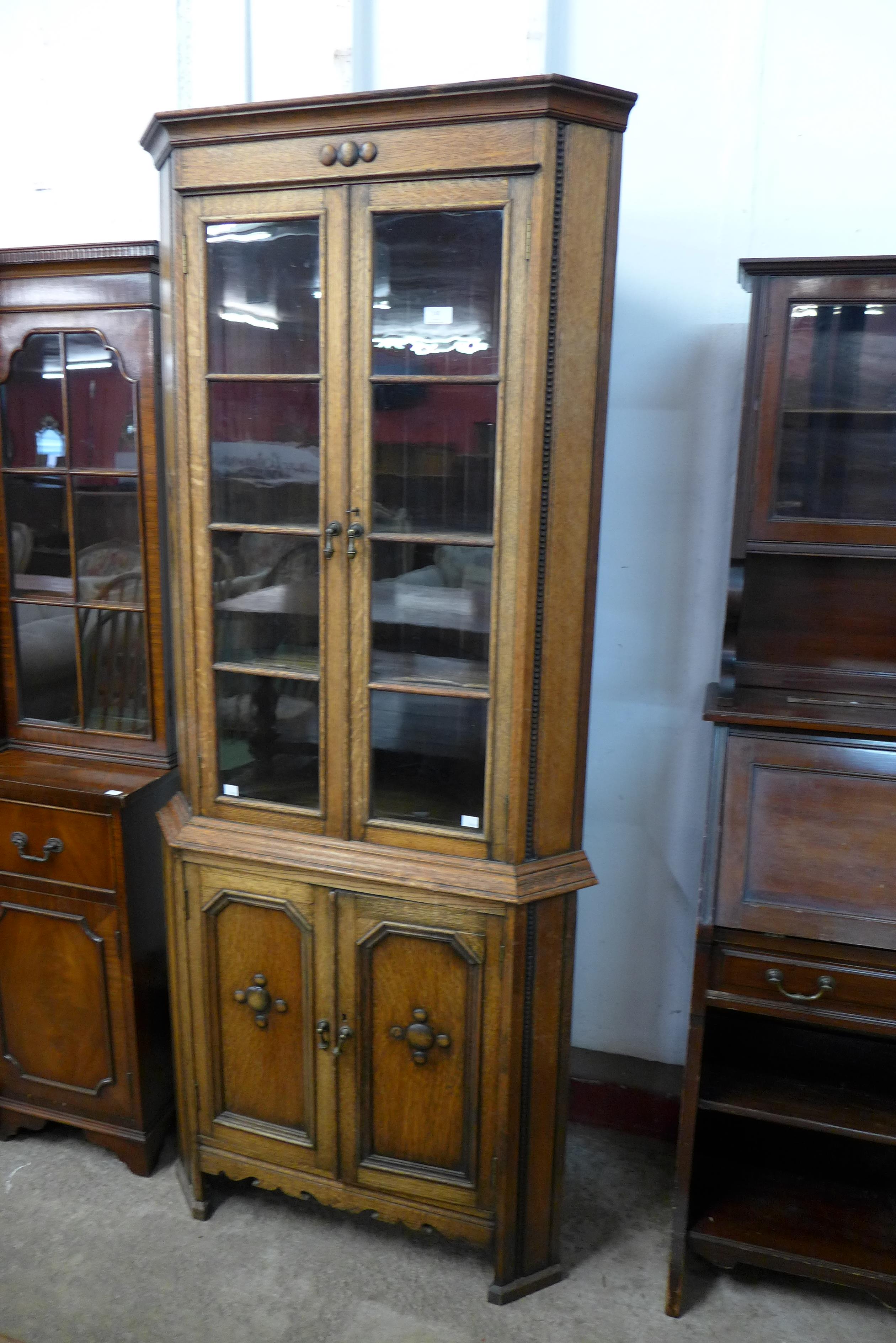 An early 20th Century oak freestanding splay front corner cabinet - Image 2 of 2