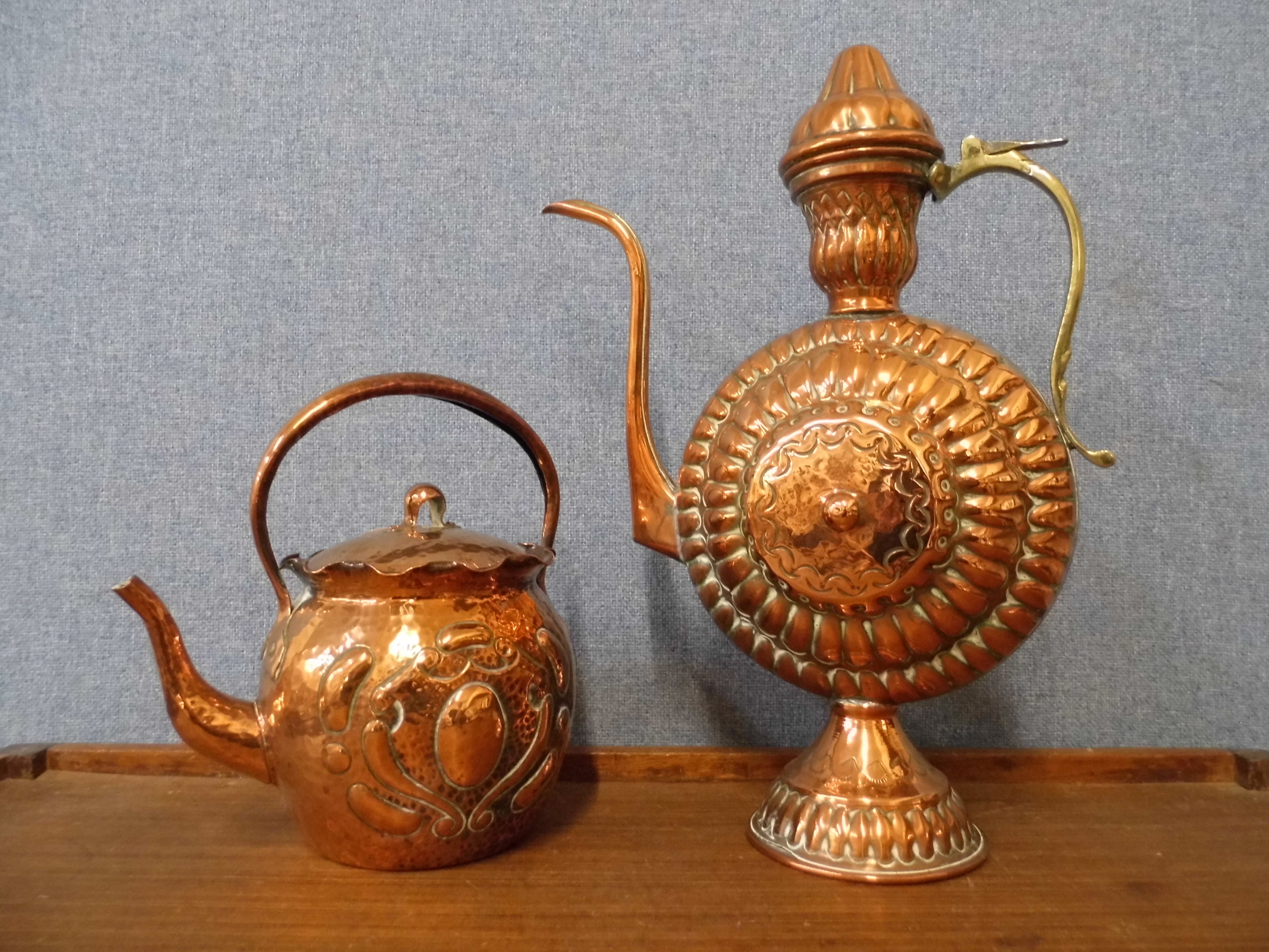 An Arts and Crafts Newlyn style copper kettle and a continental copper ewer