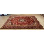 A large Persian red ground Kashan rug, 409 x 294cms