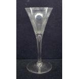An 18th Century toasting glass, circa 1750, with drawn trumpet bowl over a teared stem on a