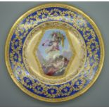 A Sevres plate with bleu lapis and gilt border with the central reserve decorated with cherubs and