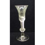 An 18th Century composite wine glass having a bell bowl with solid base over an air twist stem