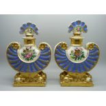 A pair of 19th Century continental porcelain flasks, decorated with flowers against a gilt and