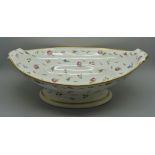 An 18th/19th Century ovoid porcelain fruit bowl, decorated with flowers, some loss of gilding, 31cm