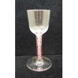 An 18th Century colour twist wine glass, circa 1770, with a round funnel bowl over the stem
