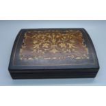 A marquetry top wooden box containing seven cigars