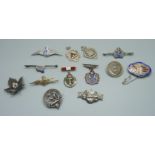 A collection of silver badges and brooches including RAF, Royal Navy, etc.