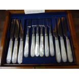 An early 19th Century mahogany cased set of twelve silver plated and mother of pearl pastry knives