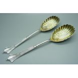 A pair of silver and gilt serving spoons with shell bowls, Sheffield 1903, 137g