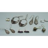 Seven pairs of silver earrings