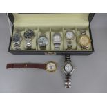 Eight wristwatches in a display box