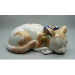 A Japanese Taisho period Kutani porcelain model of a sleeping cat, 15.5cm