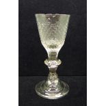 An 18th Century wine glass, circa 1720, with hammered conical bowl over a teared baluster knop