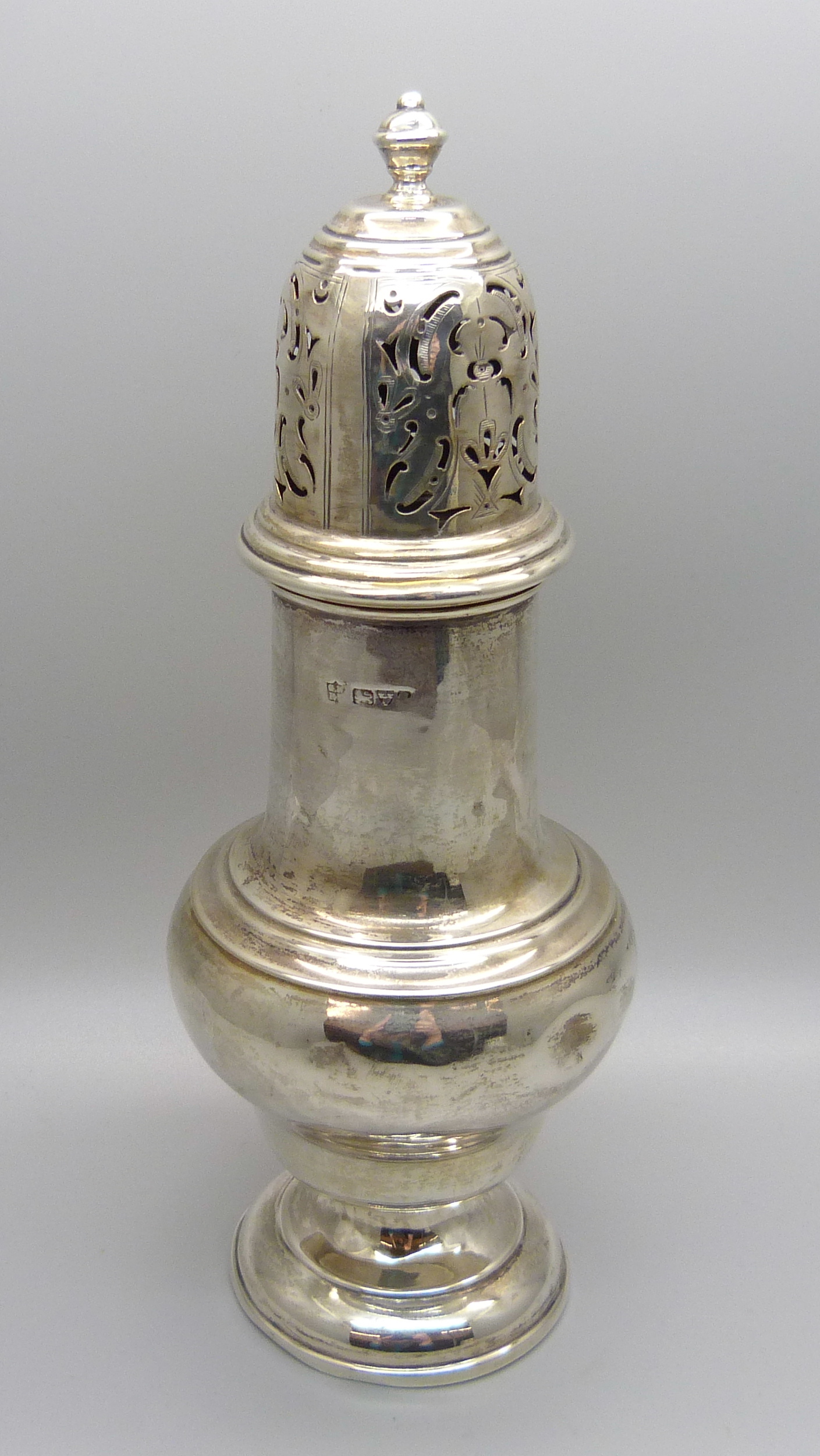 A silver castor, 145g, (with some dents)