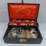 A jewellery box and contents including clip-on earrings, etc.