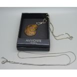 An ammonite pendant on a silver chain and one other chain, boxed