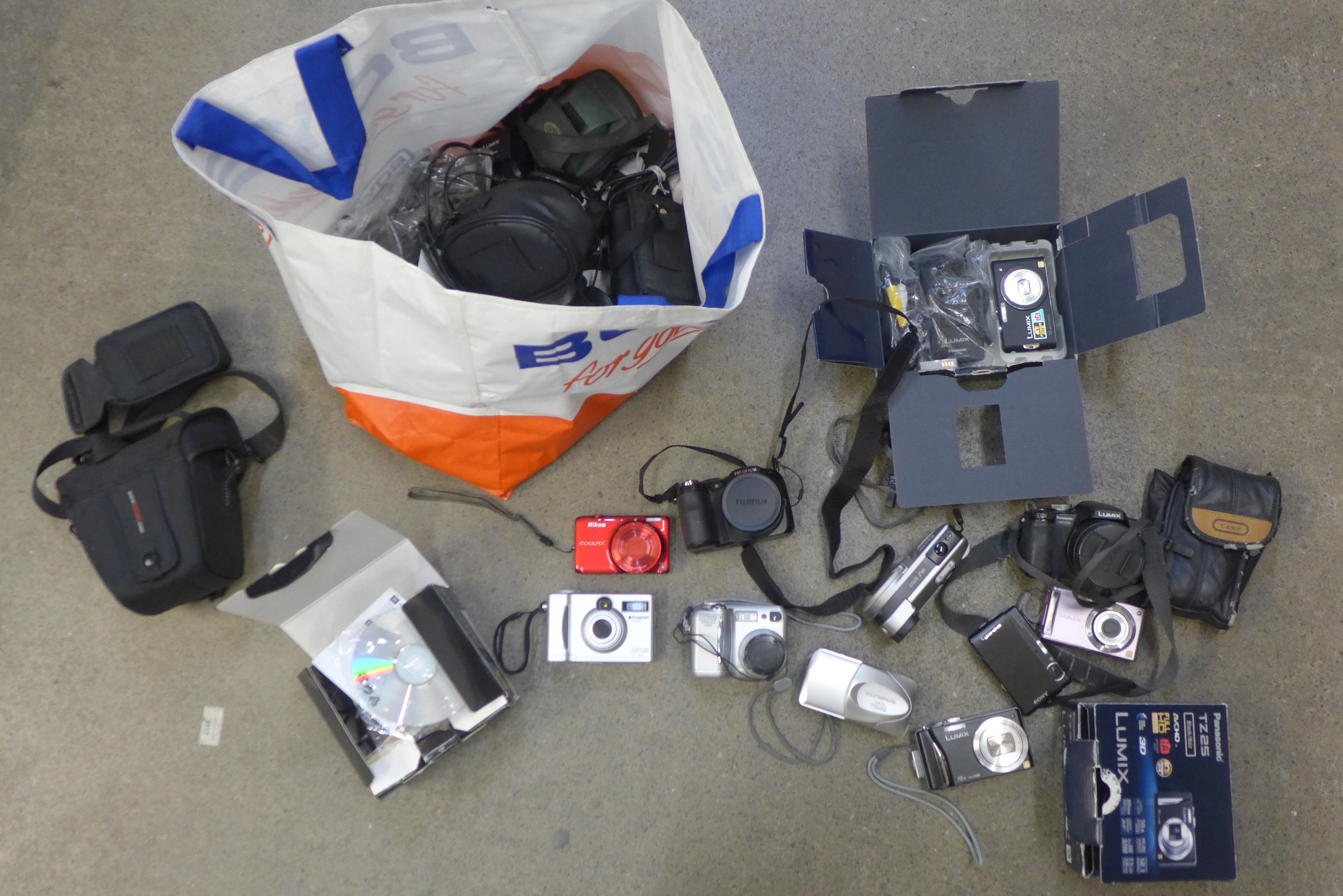 A large collection of digital cameras, Panasonic Lumix, Sony, Nikon, some boxed and with