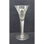 An 18th Century wine glass with trumpet bowl over an air twist stem on a wide conical foot, 18cm