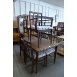 A Younger afromosia extening dining table and six chairs, designed by John Herbert