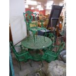 A green cast alloy garden table and four chairs