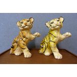 A pair of painted concrete garden figures of tiger cubs