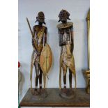 A pair of African painted carved wood tribal figures