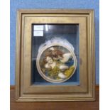 A majolica style wall plaque depicting cherubs, cased and mounted, label verso; Biggs & Sons
