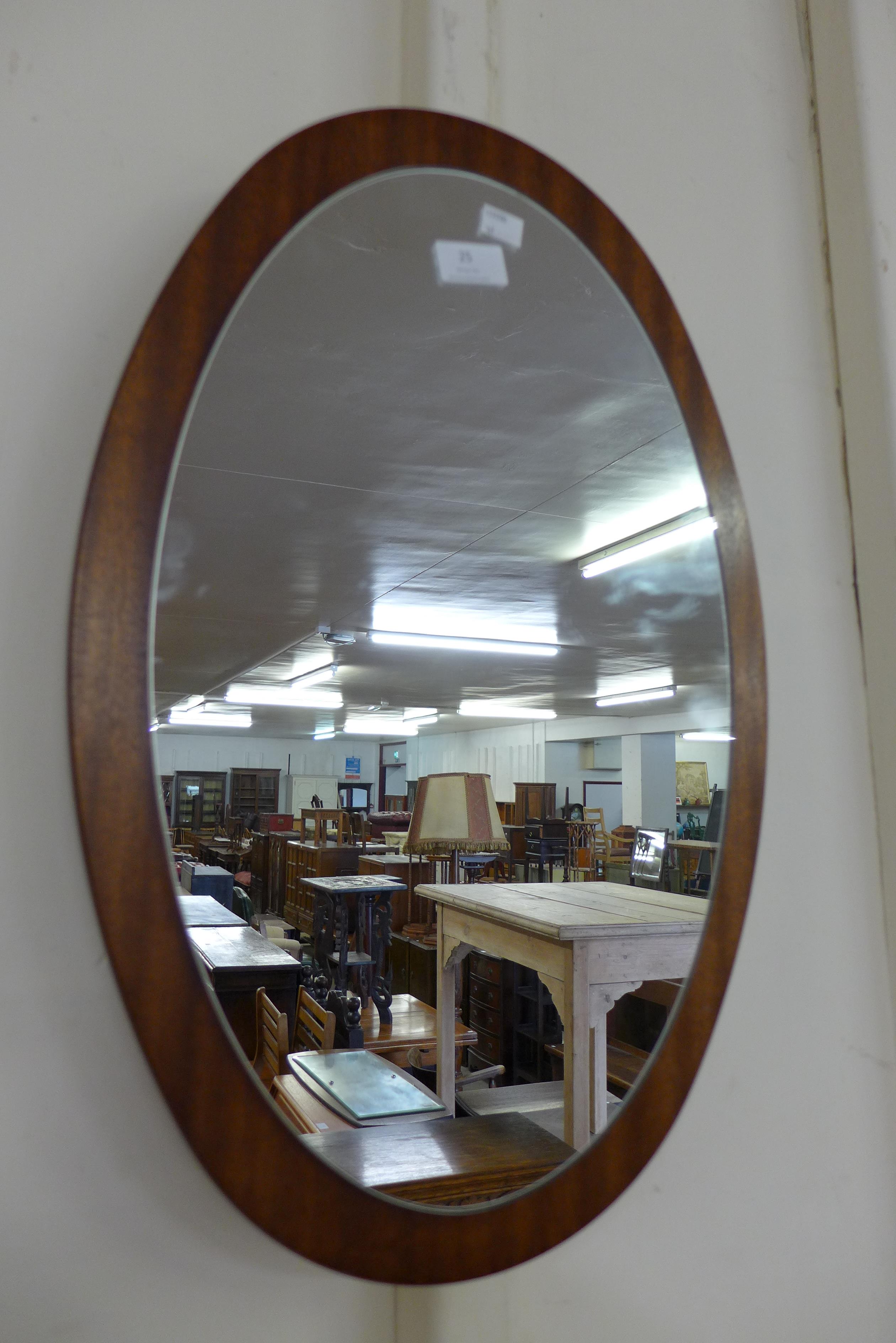 A teak framed mirror