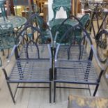 A set of four Gothic style wrought iron garden chairs