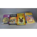 Four Harry Potter books by J.K. Rowling, two first editions