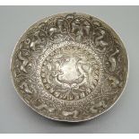 A white metal dish embossed with mythological animals and birds, diameter 12cm