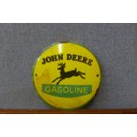A John Deere enamelled signa and a tractor steering wheel