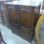 A George III style Ipswich oak four door TV cabinet