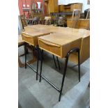 A pair of Austin Suite teak and black steel bedside tables