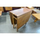 A teak drop-leaf table