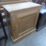 A small pine single door kitchen cupboard