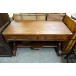 A Victorian Gothic Revival pine and pitch pine two drawer writing table