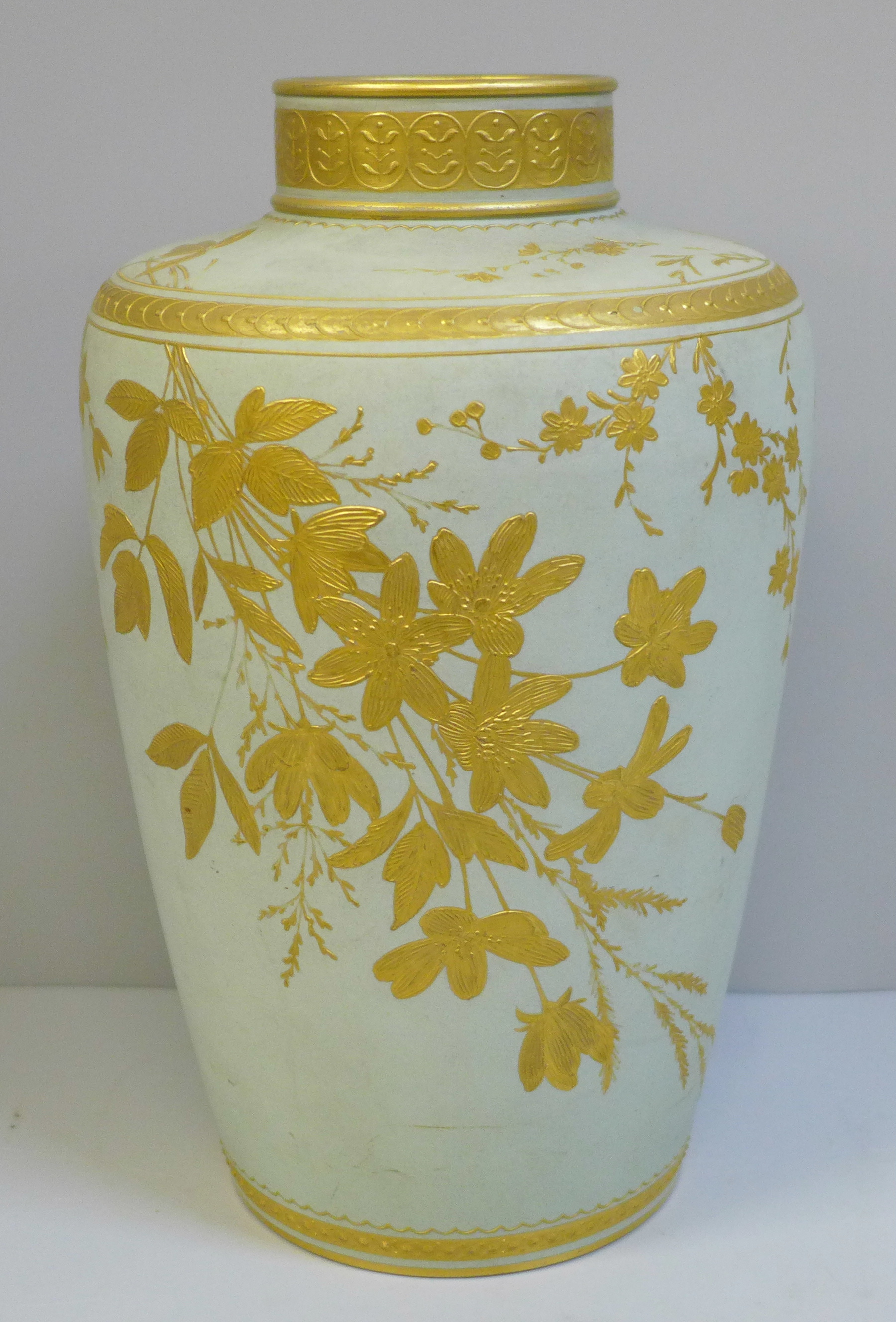 A late 19th Century duck egg blue and gilt Wedgwood vase, decorated with leaves and flowers, 22cm