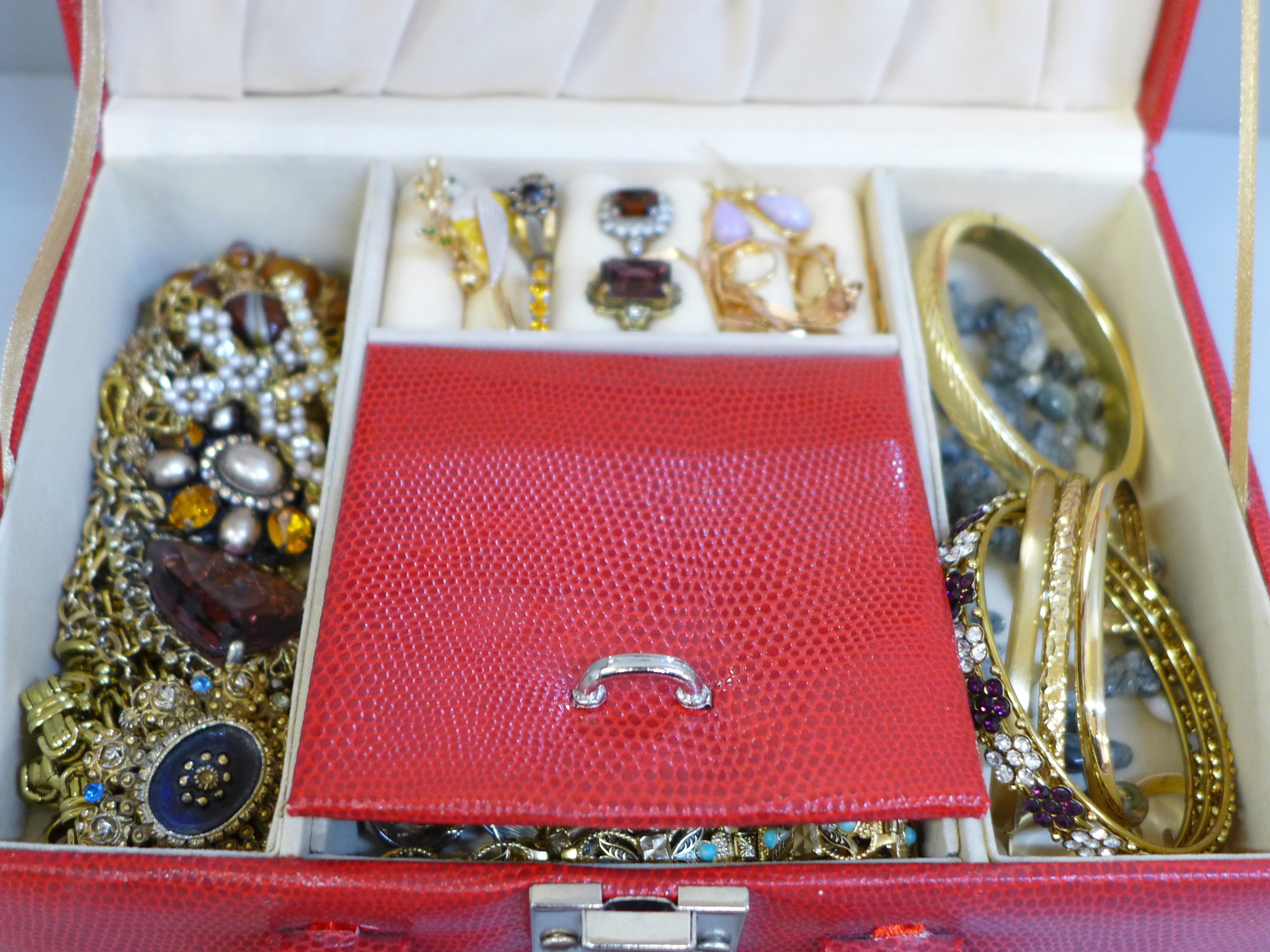 A jewellery box and contents including dress rings, gold tone, etc.
