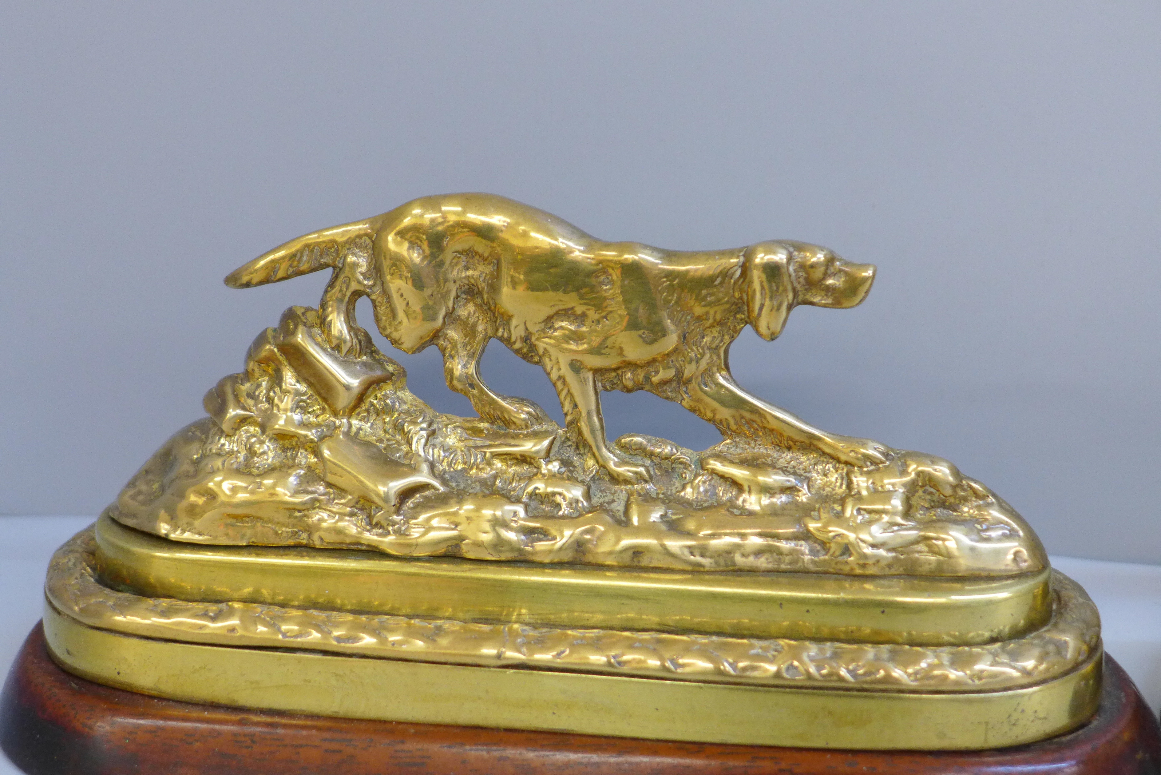 A pair of Victorian brass gun dogs on mahogany bases with traces of original gilding, 21cm - Image 2 of 4