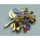 A gilt metal brooch set with gemstones, one stone replaced