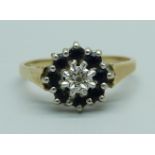 A 9ct gold ring set with a diamond and sapphires, 1.8g, M