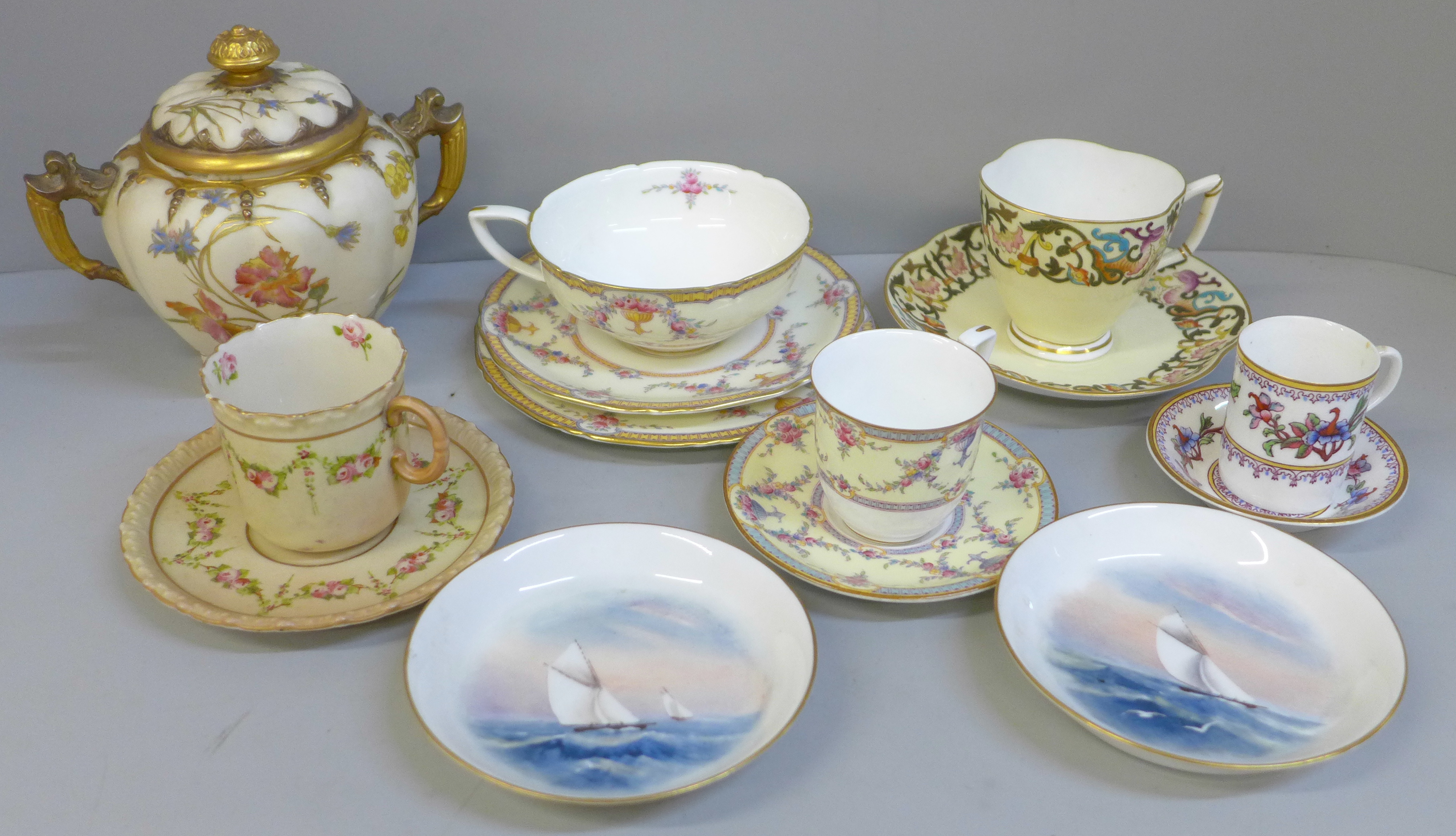 A collection of Royal Worcester porcelain including cups and saucers, trios, sugar pot, pin dishes